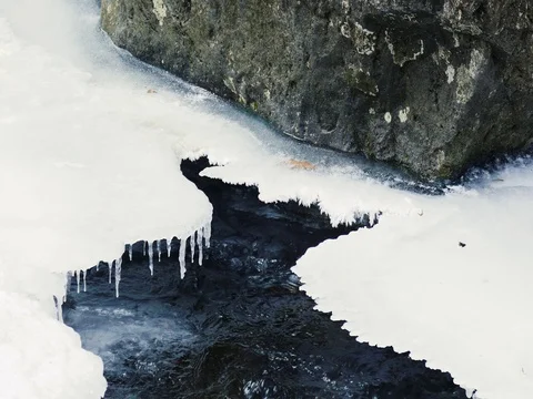 Cold Icicles Hanging over a River Stock Footage 73546497