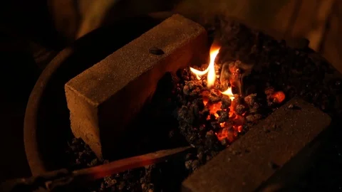 Cold iron returned to hearth fire during forging process blacksmith slow mo 動画素材 89507311