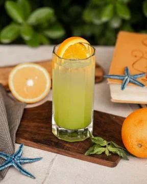 Cold lemon cocktail with orange slice Stock Photos