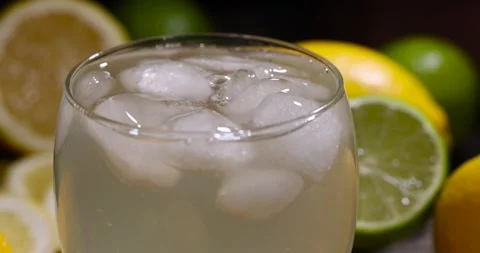 Cold lemon drink with the addition of pieces of pure ice, sweet and sour Stock Footage 320816241