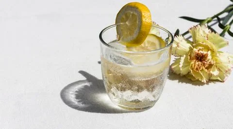 Cold Lemon Water with Carnation on Table Stock Photos