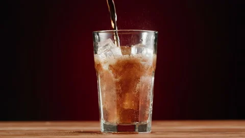 Cold lemonade in glass close-up. Cola with ice. Refreshing cocktail. Summer Stock Footage 197189923