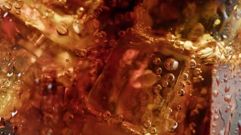 Cold lemonade in glass close-up. Cola with ice macro shooting texture 動画素材 197372331