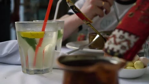 Cold lemonade with lemon and mint on a background of coffee and oriental sweets. Stock Footage 133237918