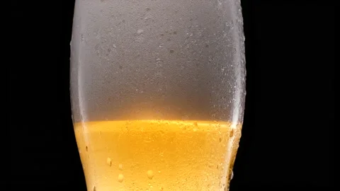 Cold light beer in a glass with water drops.  Video stock 153673449