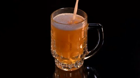 Cold light beer is poured into a glass Stock Footage 153319727