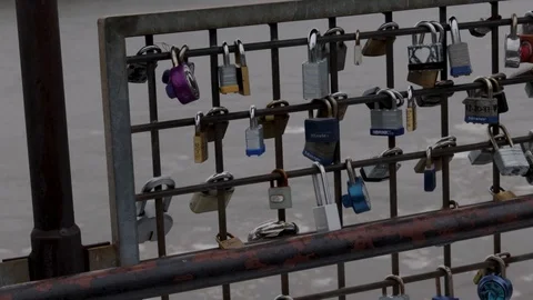 Cold Love Locks With Broken Ice Floating Past A River Of Hate Medium shot Stock Footage 103346102