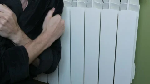 Cold Man In Bathrobe Shivering Next To White Central Heating Radiator Stock Footage 329846692