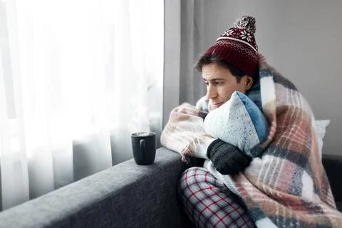 A cold man faces a home heating problem during an energy crisis and cold sn.. 스톡 사진