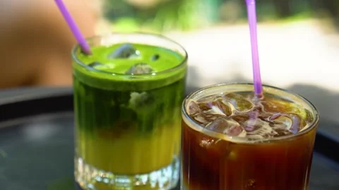 Cold matcha with ice and ice coffee on the coffee table. Stock Footage 280438048