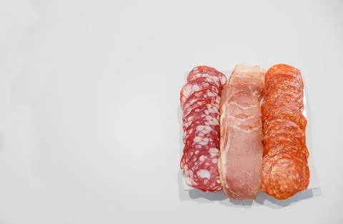 Cold meat plate. Appetizer with ham, prosciutto, salami on a white background Stock Photos