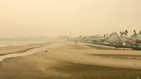 Cold misty yellow day at beach at boardwalk with games and entertainment Stock Footage 143301731
