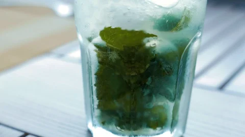 Cold mojito cocktail with Icecubes, mint and limes. Stock Footage 128730947