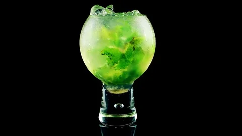 Cold Mojito cocktail with lime, mint and ice on black background 스톡 동영상 75626768
