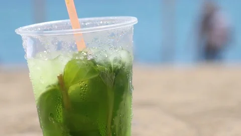 Cold Mojito drink sitting on the sand Stock Footage 75818735