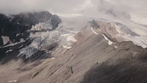 Cold mountain peaks covered by snow and glaciers. Top view on snow icy landscape Stock Footage 203824932