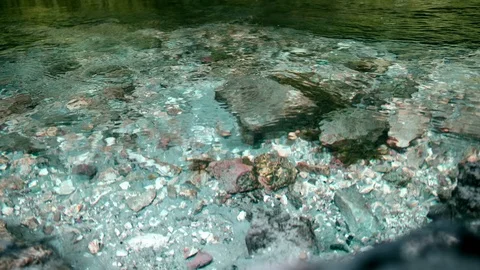 Cold mountain river flows among stones. cold and clear, turquoise river . Video stock 123469416