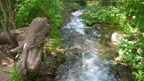 Cold mountain river flows among stones. cold and clear, turquoise river . Video stock 123483754