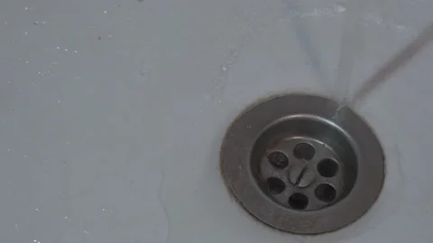Cold or hot water flows in old sink with rusty metal grid. Stock Footage 169541375
