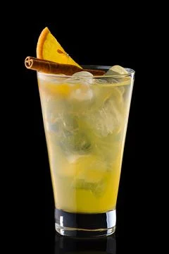 Cold orange and cinnamon refreshing drink in tall glass isolated on black Stock-Fotos