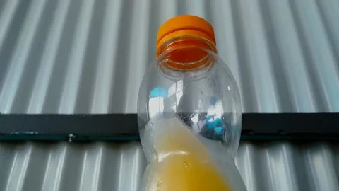 Cold Orange drink In Transparent Bottle Stock Footage 156013023