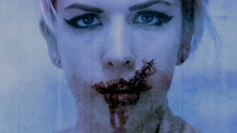 Cold pale blue torn and stitched mouth stop motion style horror loop Stock Footage 133253594