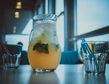 Cold Pitcher of lemonade on the table in a restaurant Stock Photos