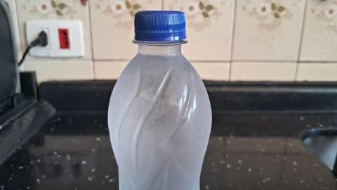 Cold plastic water bottle with a bright blue screw cap Stock Photos