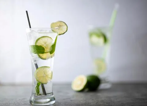 Cold refreshing beverage with sliced lime ripes and ice reverse light image i Photos