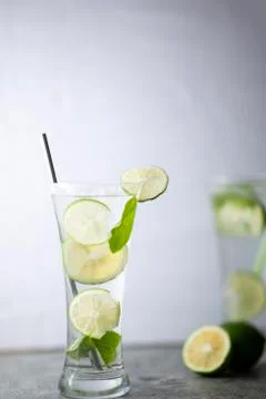 Cold refreshing beverage with sliced lime ripes and ice reverse light image i Photos