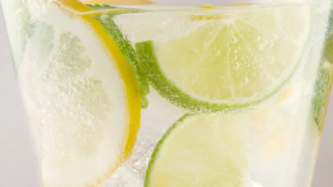 Cold refreshing citron tonic, lemonade or cocktail with ice cubes and fresh mint Stock Footage 155605917