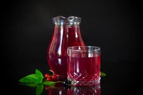 Cold refreshing drink from fresh summer berries in a decanter. 写真素材