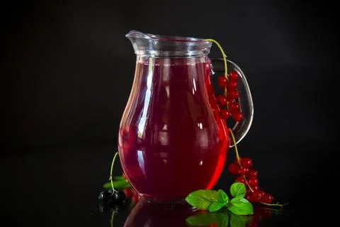 Cold refreshing drink from fresh summer berries in a decanter. Stock Photos