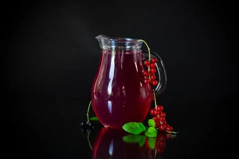 Cold refreshing drink from fresh summer berries in a decanter. 写真素材