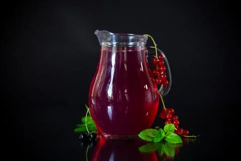 Cold refreshing drink from fresh summer berries in a decanter. Stock Photos