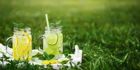 Cold refreshing homemade lemonade with mint, lemon and lime in mason jars on  Stock Photos