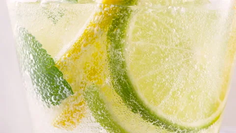 Cold refreshing lime soda or mojito cocktail with ice cubes and fresh mint Stock Footage 154982600