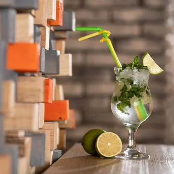 Cold refreshing mojito with mint leaves and a slice of lime. Glass of citrus Stock Photos
