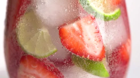 Cold refreshing strawberry and lime lemonade with ice cubes. Berry and lime.. Stock Footage 275882097