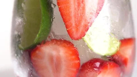 Cold refreshing strawberry and lime lemonade with ice cubes. Berry and lime.. Stock Footage 276893330