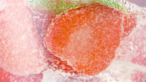 Cold refreshing strawberry lemonade or mojito cocktail with ice cubes and fresh Stock Footage 155605807