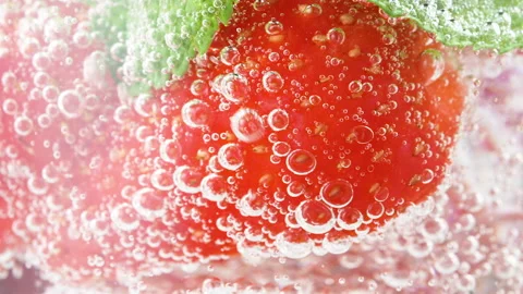 Cold refreshing strawberry lemonade or mojito cocktail with ice cubes and fresh Stock Footage 168936592