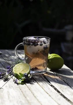Cold refreshing tea with blueberry, lime and lavender on a hot summer day Stock Photos
