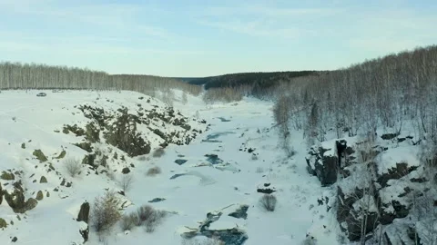 Cold river flowing through dense snow covered pine forest in wild winter 스톡 동영상 165346148