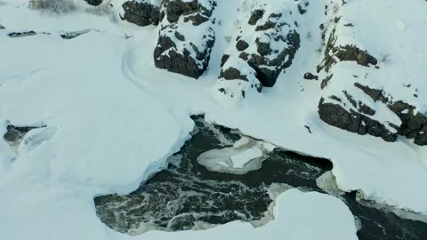 Cold river flowing through a dense snow covered pine forest in wild winter Video stock 165346726