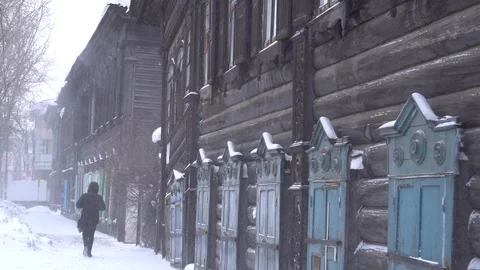 Cold Siberian winter men walk the street wooden old house Steadicam cinematic. Stock Footage 88465121