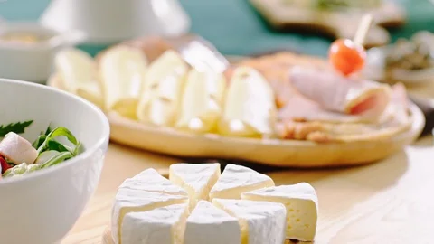 Cold Snacks Board of Various Kinds Of CheeseWith Meats, Salads, Olives Stock Footage 124042963