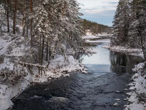 The cold snow winter river in evening light Stock Photos