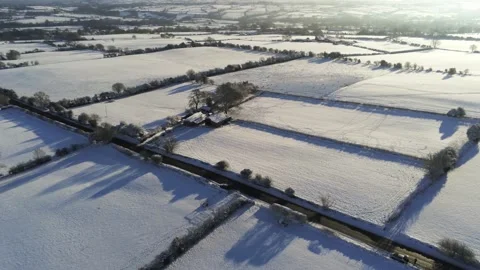 Cold snowy winter British patchwork farmland countryside rural scene Stock Footage 146523106