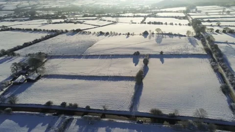 Cold snowy winter British patchwork farmland countryside rural scene Video stock 146523234